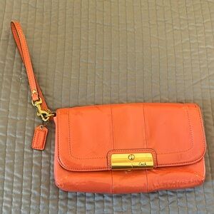 Pretty deep-peach colored leather Coach wristlet